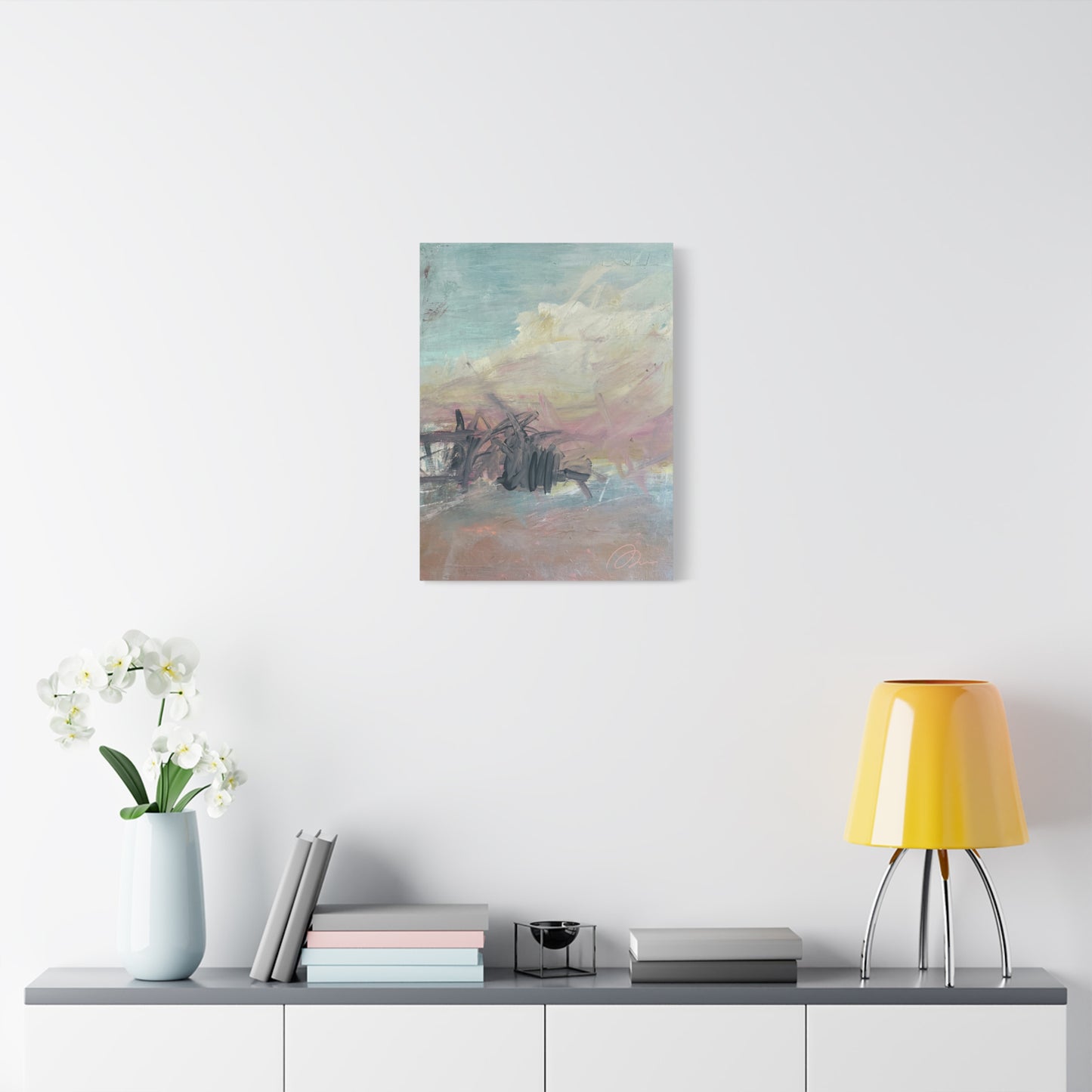 Abstract painting on a wall above a shelf with decor items